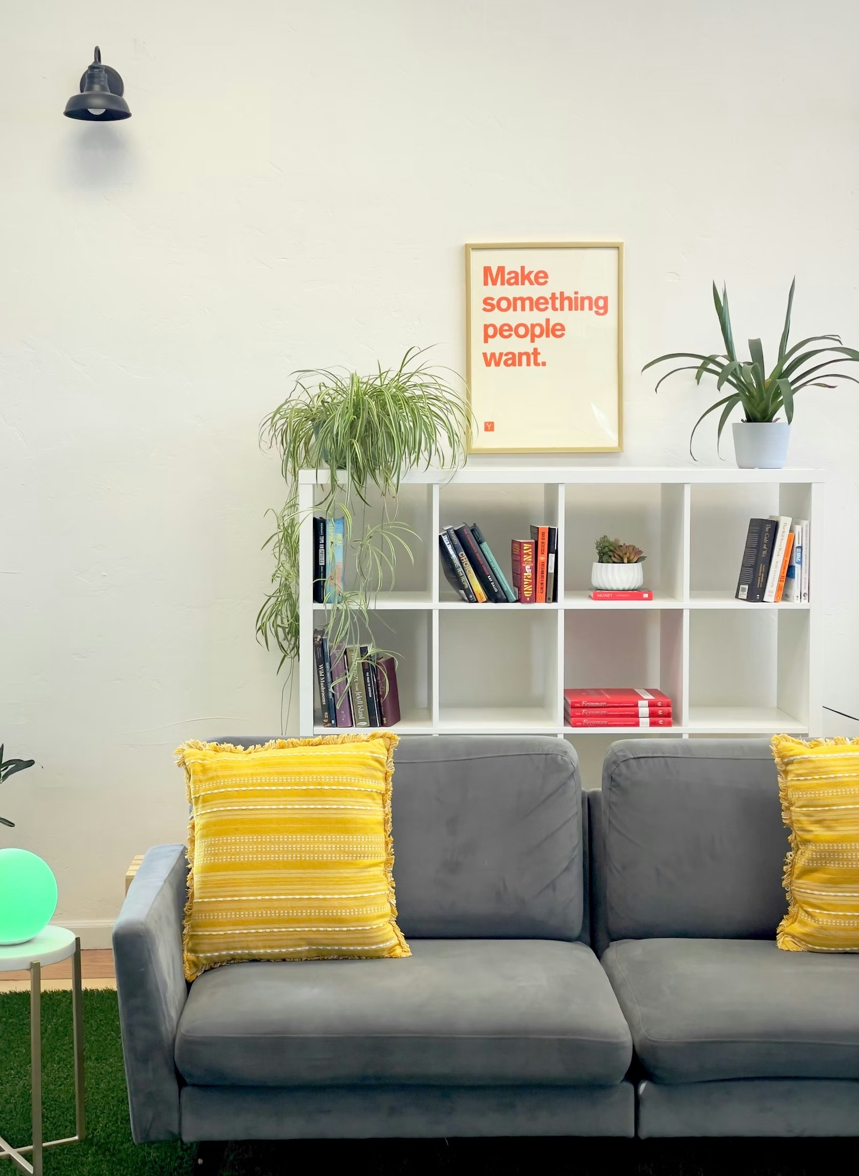 Breckworks shared coworking space with a couch, and a small library of interesting books to browse.