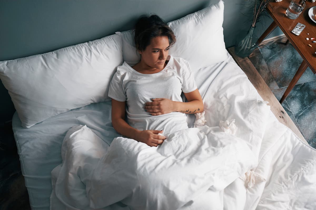 Woman in bed with altitude sickness Woman in bed with altitude sickness
